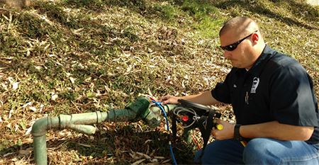 Man conducting a backflow test